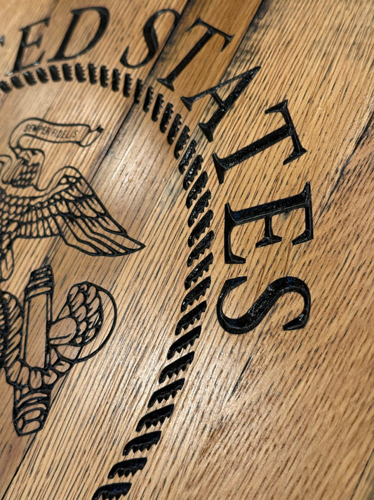 closer image of Bourbon Barrel lid with "United States" upper rocker, "Marine Corps" lower rocker, and the Corps emblem in center