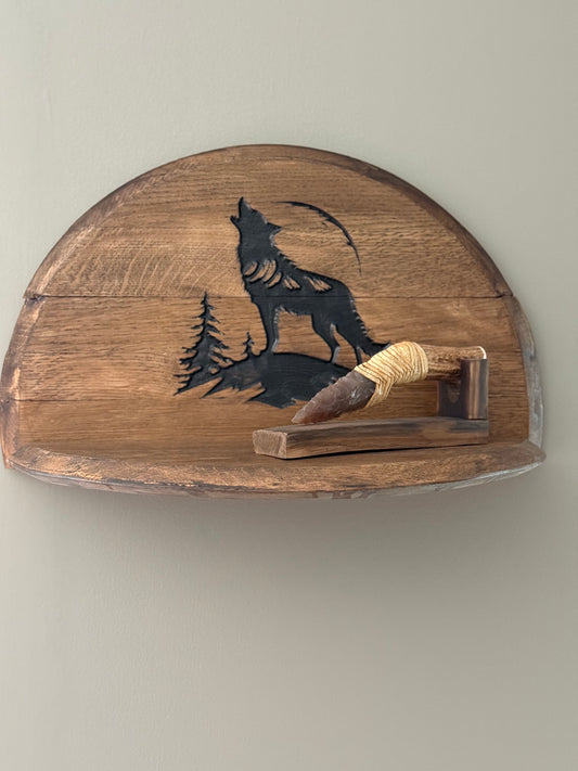 Bourbon barrel lids split to create a shelf . Lid engraved with image of wolf howling on mountaintop and two pine trees in background. (Shown with knife not for sale.)