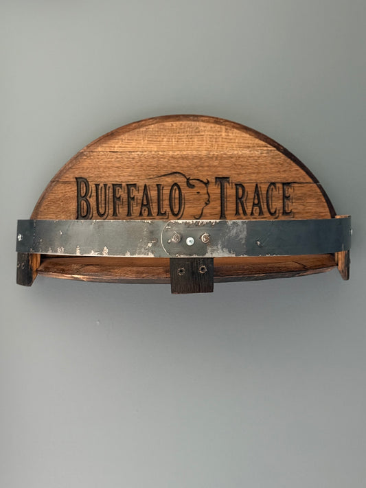 Bourbon barrel lids split to create a shelf bordered by small pieces of stave with metal barrel band. Lid engraved with "Buffalo Trace" and outline of buffalo in center.